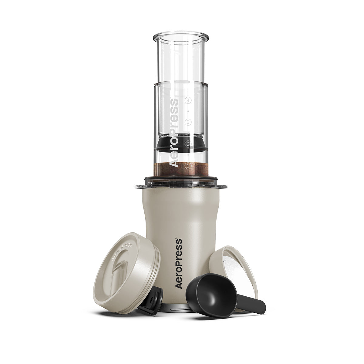 Aeropress coffee maker with components on a white background