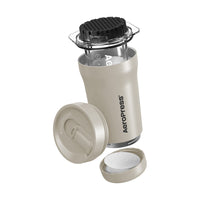 Aeropress coffee maker with components on a white background